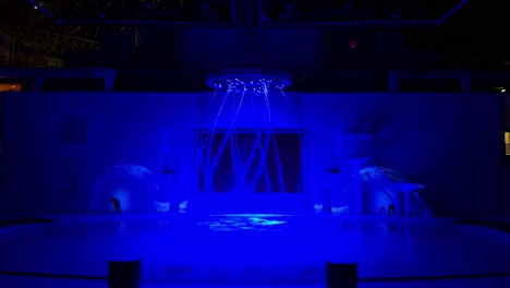 a glowing fountain streams vibrant purple water in a futuristic indoor space under neon lights