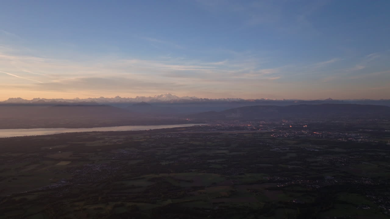 Peaceful morning in Geneva with the iconic Jet d’Eau rising from the lake, calm waters reflecting the clear sky, and the city slowly coming to life in the morning light.