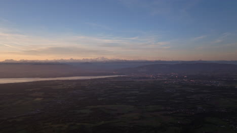 peaceful morning in geneva with the iconic jet d’eau rising from the lake, calm waters reflecting the clear sky, and the city slowly coming to life in the morning light.