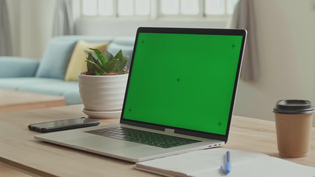 Laptop With Green Screen Display On The Table, Video In 4K