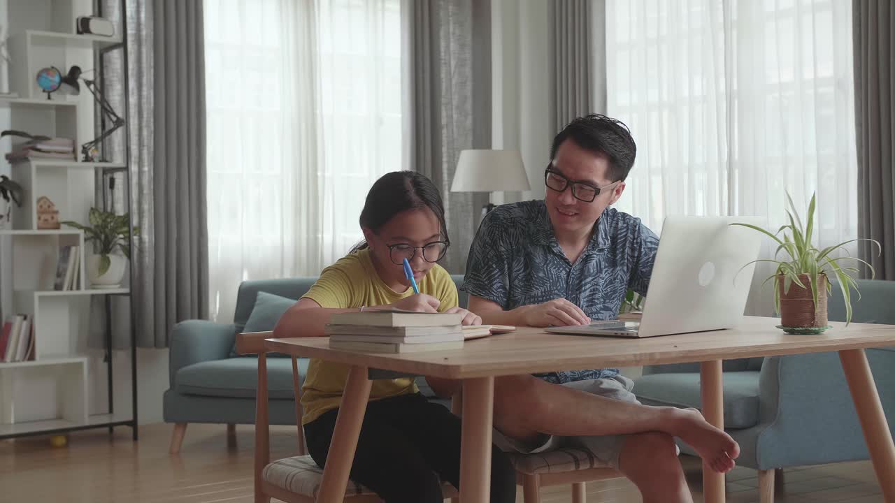 Father helping daughter with online homework