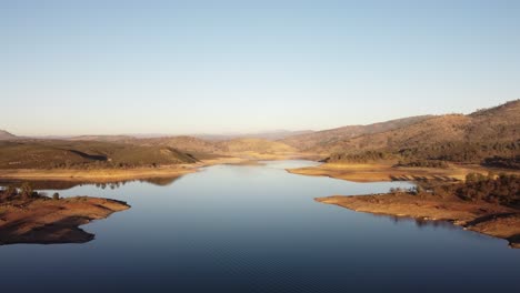 Rolling hills and tree-lined shores frame the serene waters of New Hogan Lake in this aerial view.