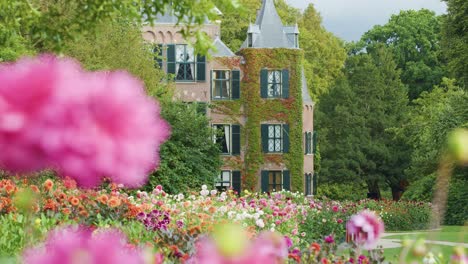 historic castle framed by vibrant spring flowers, soft focus foreground, gentle camera movement, natural daylight