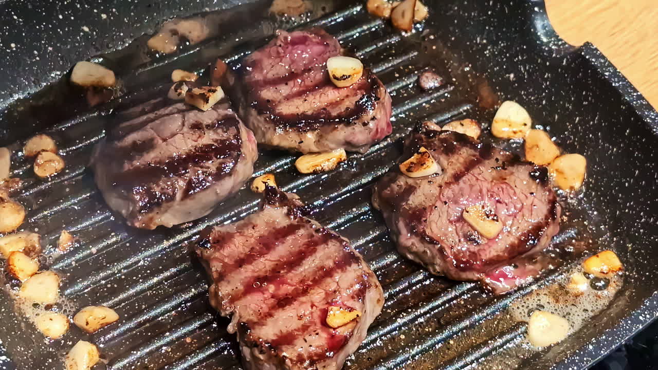 Closeup view of meat being grilled on a pan