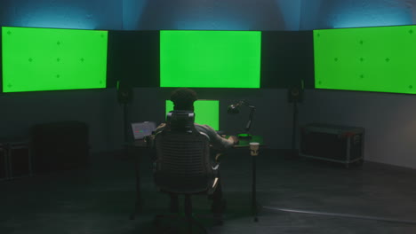 video editor in a green screen studio