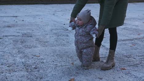 baby learning to walk in winter