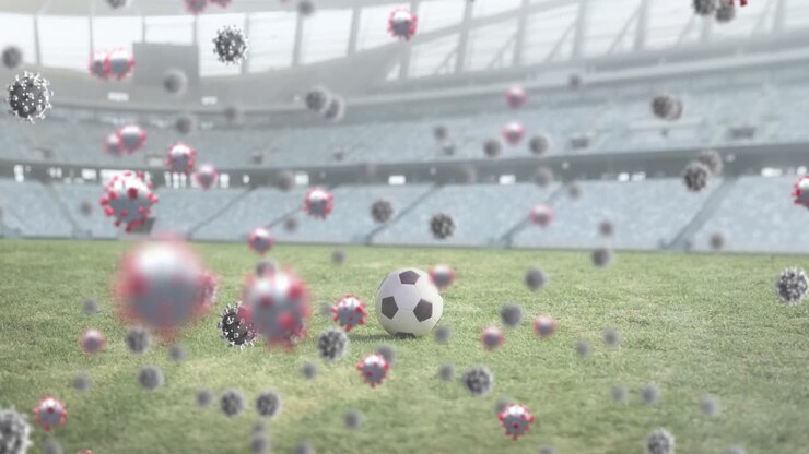 Cellule Covid-19 contro un pallone da calcio in uno stadio sportivo