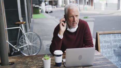 caucasian man out and about in a coffee wearing a face mask against coronavirus