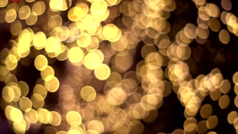 abstract blurred gold glitter with bokeh effect on dark background