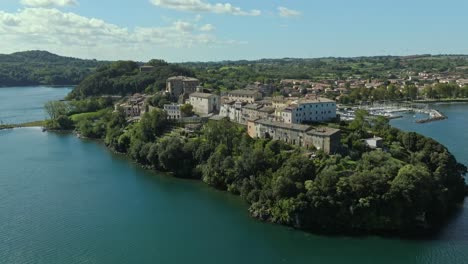 aerial around the rocca farnese castle and old town of capodimonte on lake bolsena, province of viterbo, italy