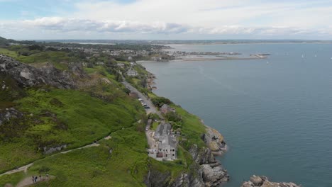 large skyline drone aerial panoramic and landscape view of green mountain and irish sea on a bright blue sunny day