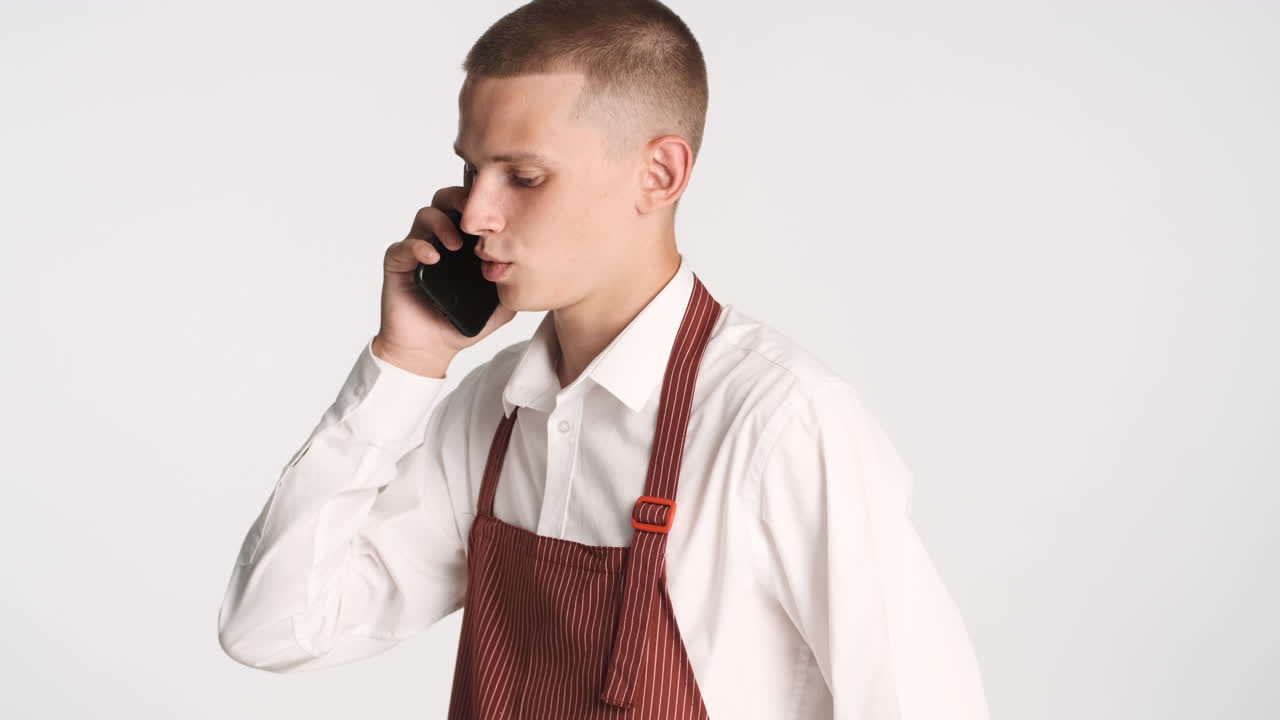전화로 얘기하는 젊은 웨이터