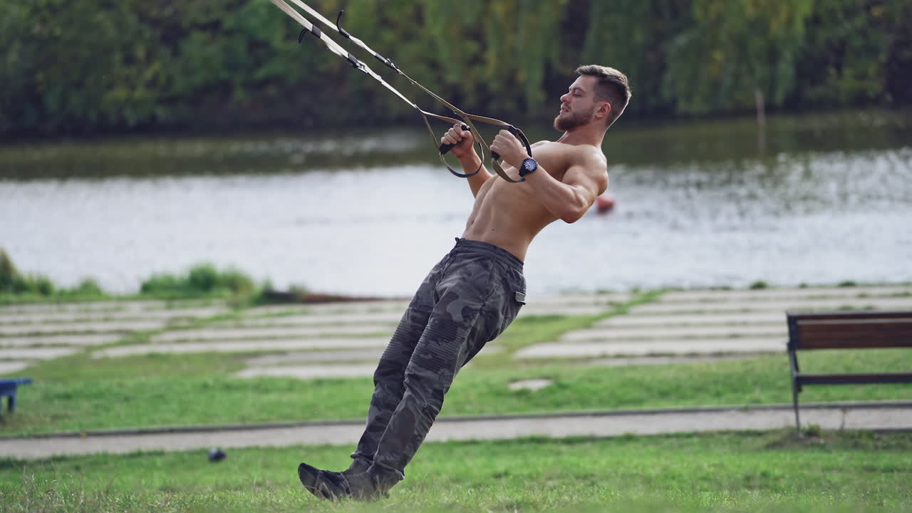 Man doing exercise outdoors. Fit young man exercising in park