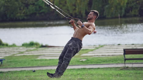 man doing exercise outdoors. fit young man exercising in park