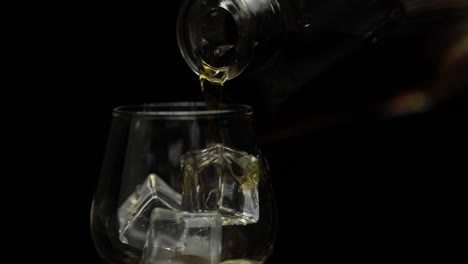 pouring whiskey on the rocks