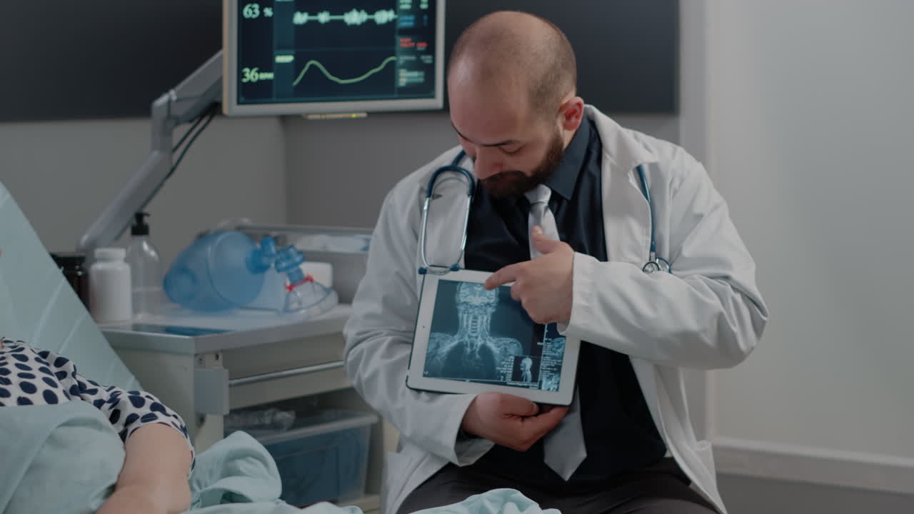 Sick patient looking at x ray scan on tablet for exam results