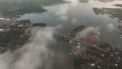puente de río dulce bridge guatemala with low clouds, aerial
