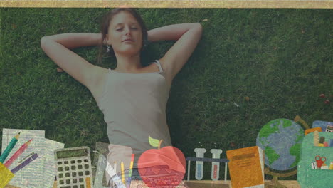 School concept icons against girl laying on the grass
