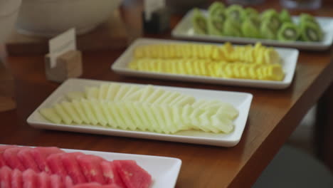 breakfast brunch served with big bowls and plates with fruits, vegetables and bread