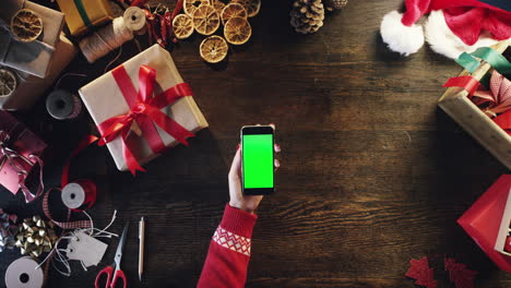 Top-view-woman-hands-using-touchscreen-smartphone-tablet-hand-gestures-green-screen-table-from-above---Red-Epic-Dragon