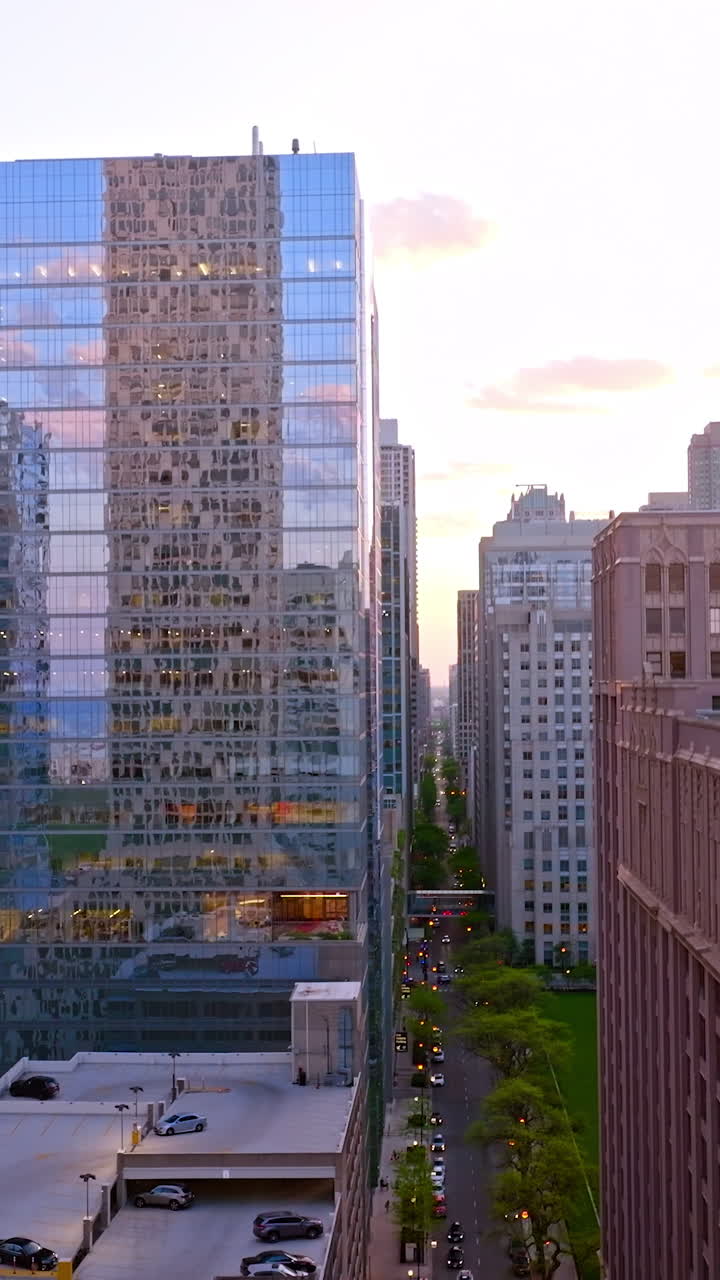 Drone raising high above the long street in Chicago. Beautiful architecture in the amazing metropolis. Vertical video