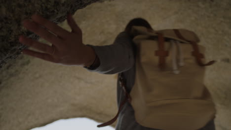 close up beautiful young tourist woman exploring seaside caves smiling enjoying travel lifestyle adventure alone on vacation