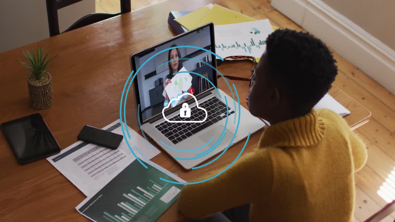Animation of cloud with digital padlock over african american woman having video call on laptop