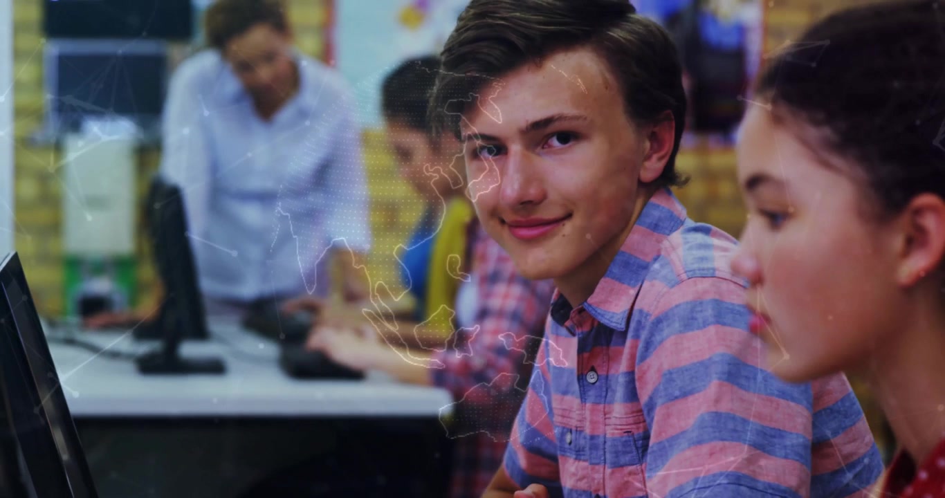 students typing in school lab initiating map overlay pulsing, boy glancing up smiling for education