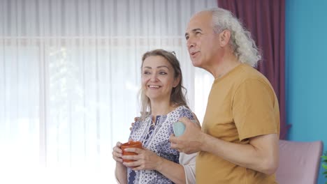 Happy-couple-enjoying-coffee-at-home.