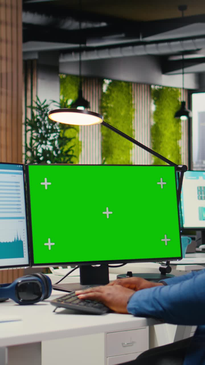 Vertical Video African american man engaged in business planning with a green screen