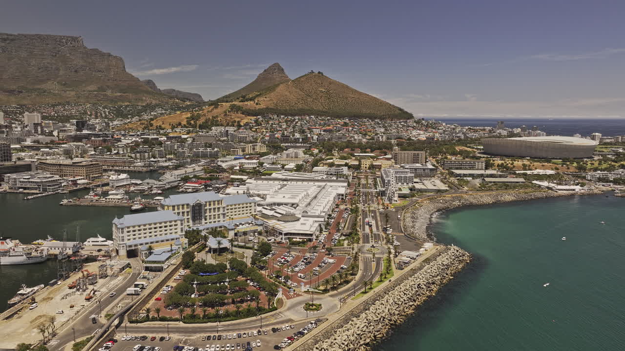 Cape Town South Africa Aerial v46 flyover pier, capturing the VA Waterfront, harbor marina, and downtown cityscape with Table Mountain's dramatic backdrop - Shot with Mavic 3 Pro Cine - Jan 11th 2024