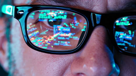 close-up of an eye with code reflection in glasses