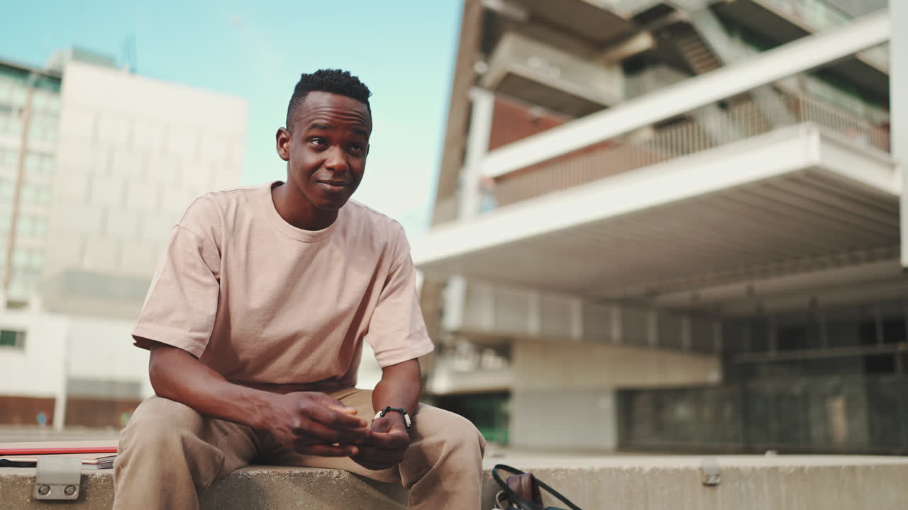 Young Man Sitting in Urban Setting