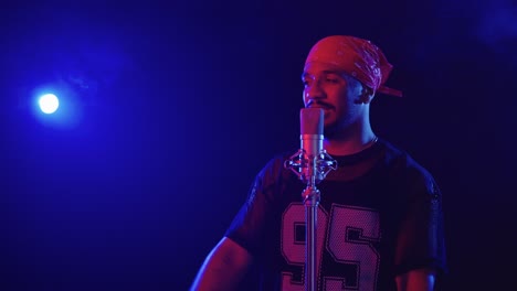 Man singing into microphone in a music studio
