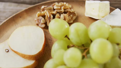 slices of cheese with walnuts, grapes and jam