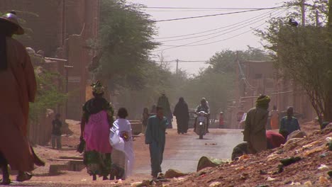 La-Gente-Camina-Por-Una-Carretera-A-Través-Del-Desierto-Del-Sahara-En-Malí-Durante-Una-Tormenta-De-Viento-1