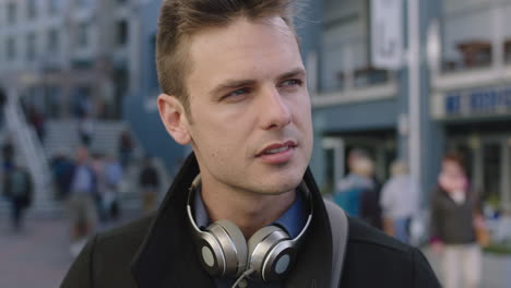 close up portrait of attractive young caucasian waiting looking confident at camera in busy urban background