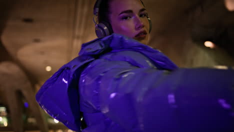 Woman-posing-wearing-headphones-in-evening-city-close-up.-Girl-listening-music