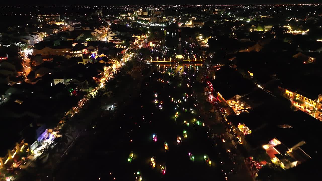 Hoi an, vietnam with vibrant lights and lanterns along the river, aerial view