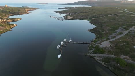 still waters with small sailboats docked at sa nitja natural port