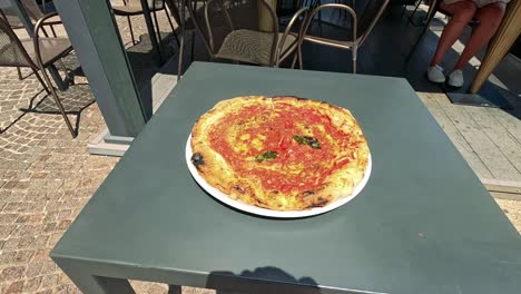 a pizza on a table in naples, italy