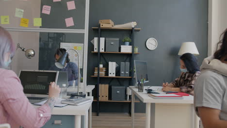 Office Workers in a Modern Workspace During the Pandemic
