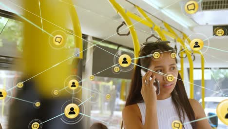 animation of network of digital icons over asian woman talking on smartphone in the bus