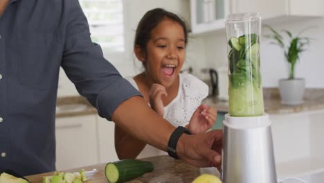 Padre-Hispano-Con-Hija-Sonriente-Enseñando-A-Hacer-Batidos-En-Licuadora