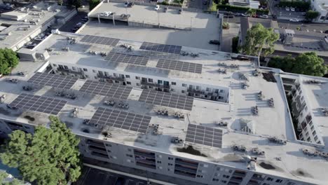 sherman oaks encore apartments building, aerial descending over solar panels on roof