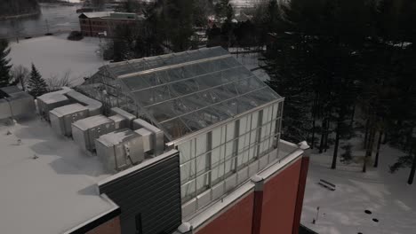 Morris-House-Behind-Norton-Poillack-Residence-In-Bishops-University-With-Snow-filled-Ground-In-Sherbrooke,-Quebec---aerial-drone-reveal