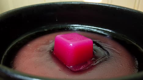 a red block of wax in placed to be melted