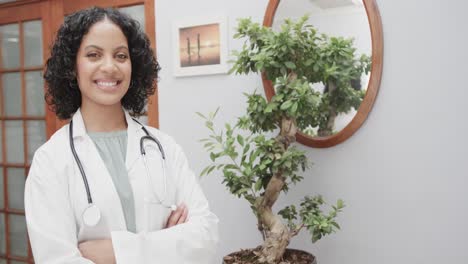 Portrait-of-biracial-female-doctor-wearing-lab-coat-and-stethoscope,-copy-space,-slow-motion