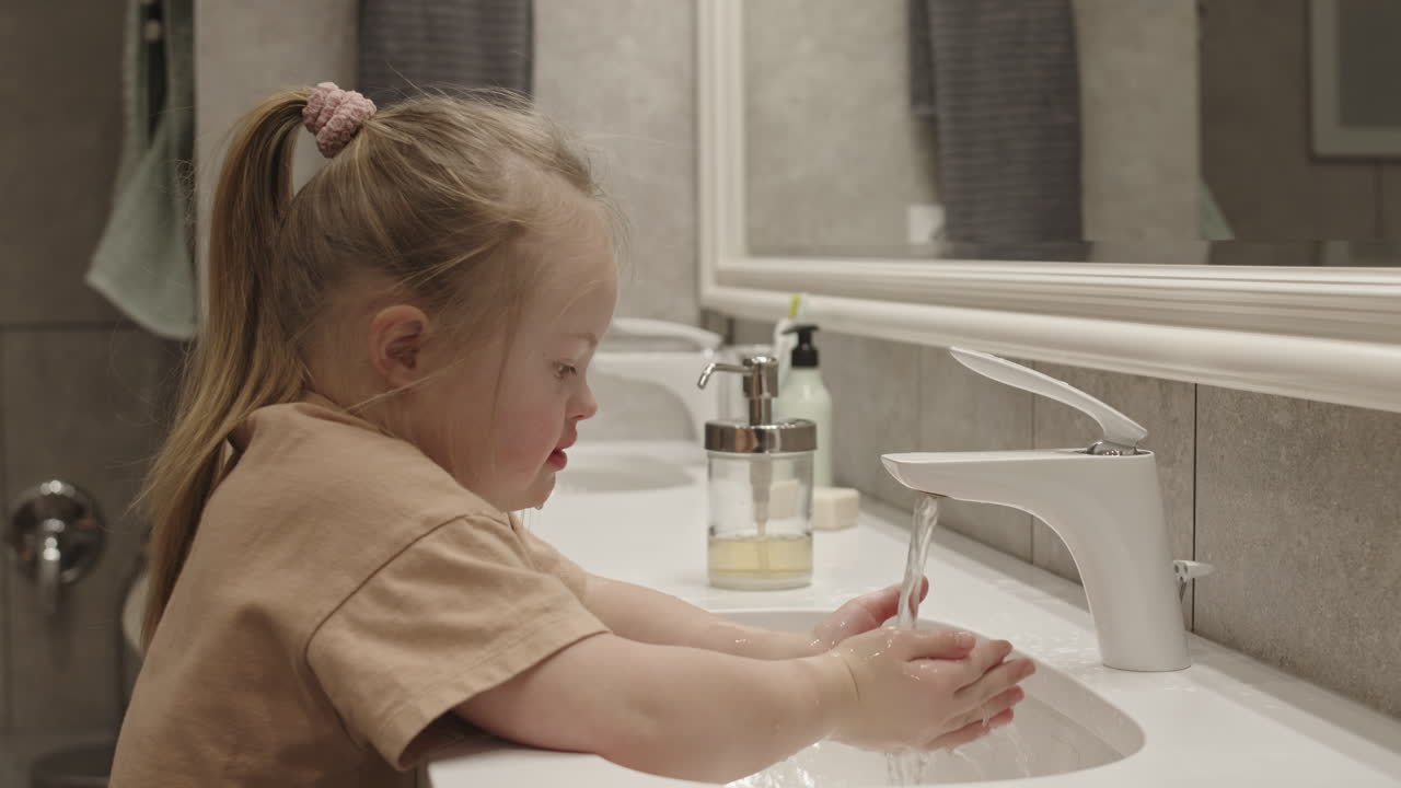 Girl Washing Hands in Bathroom