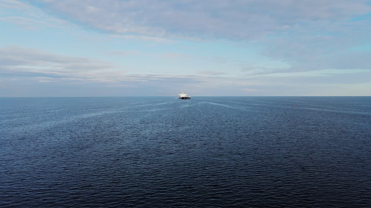 Drone captures a ship moving through the Baltic Sea, leaving a gentle wake, 4K